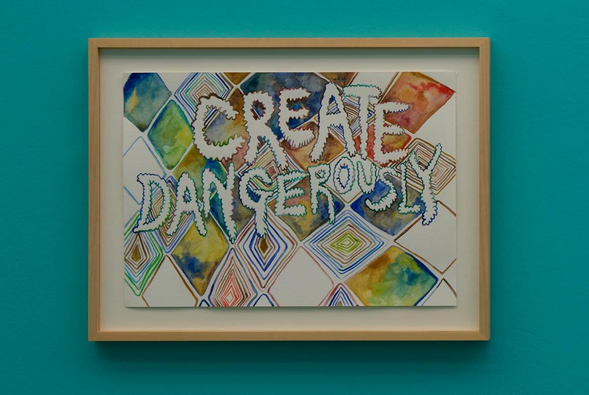 Photograph of the an artwork in which the words 'create dangerously' are written